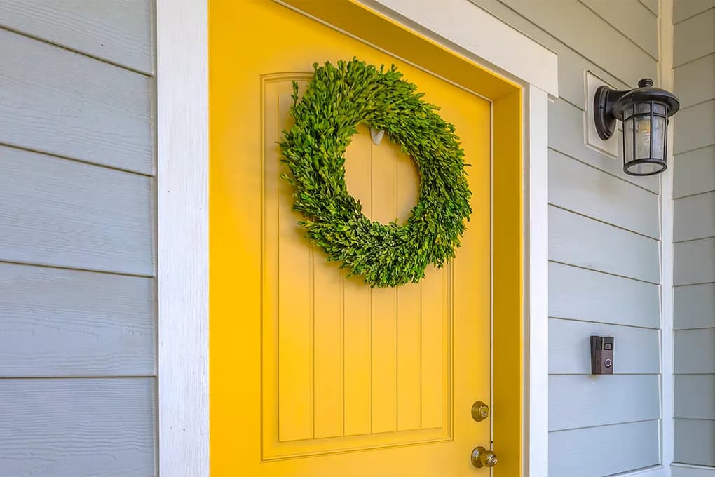 Front door painted a bold welcoming yellow