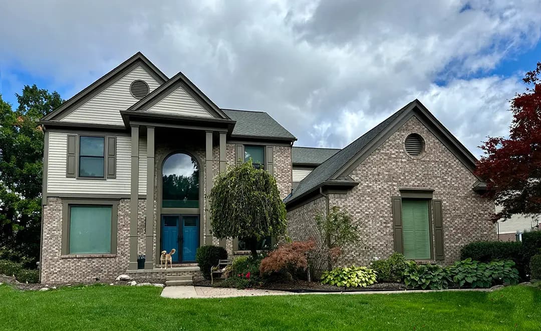 Exterior painting project at 441 Franklin Wright Boulevard, Orion Township — Grant Beige - Benjamin Moore Vinyl Safe