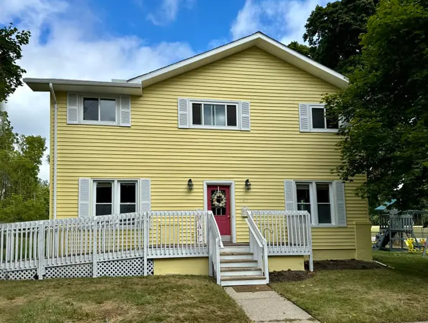 Exterior painting project at 447 East Jackson Street, Orion Township — Hawthorne Yellow- Benjamin Moore Vinyl Safe