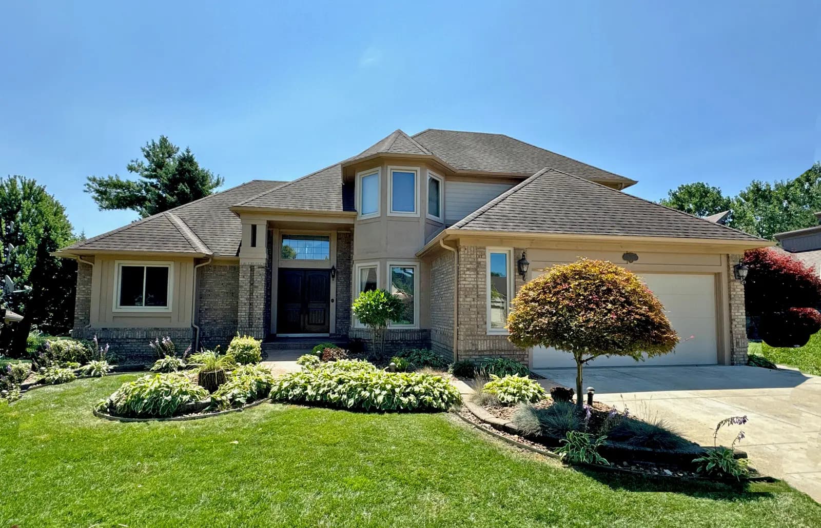 Exterior painting project at 14594 Patterson Drive, Shelby Township — Pavillion Beige - Sherwin Williams